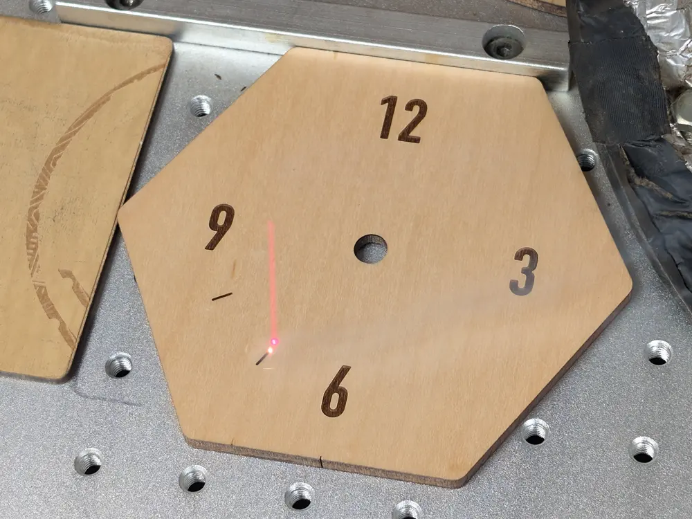 CO2 laser engraving the clock face.
